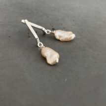 Perpetual motion pearl stud earrings with elongated amorphous freshwater pearls